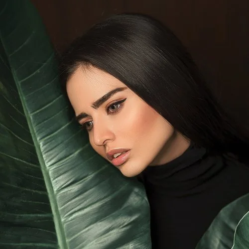 Portrait of a woman with green leaves